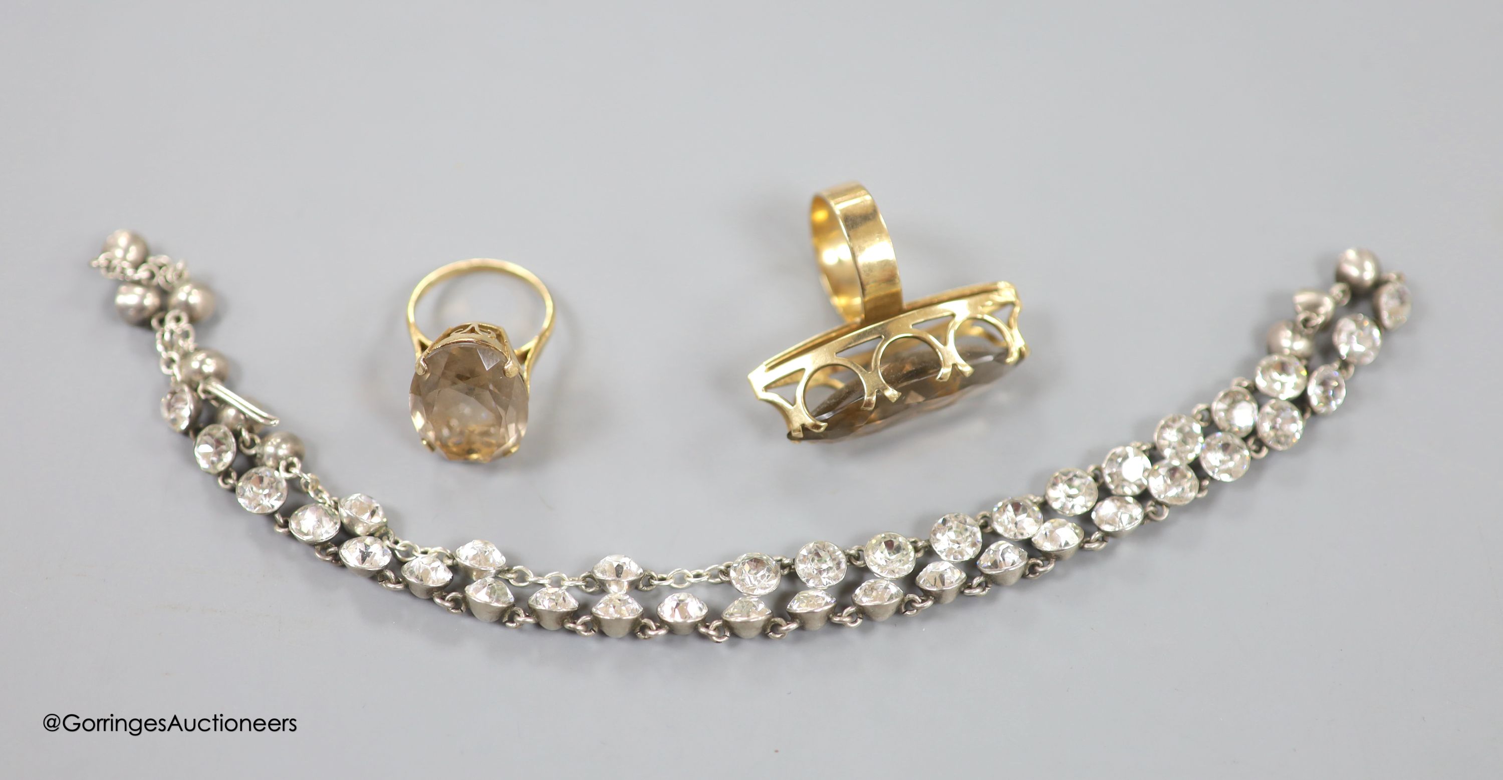 Two modern 9ct gold and smoky quartz set dress rings, gross weight 18.3 grams and a white metal and paste set necklace.